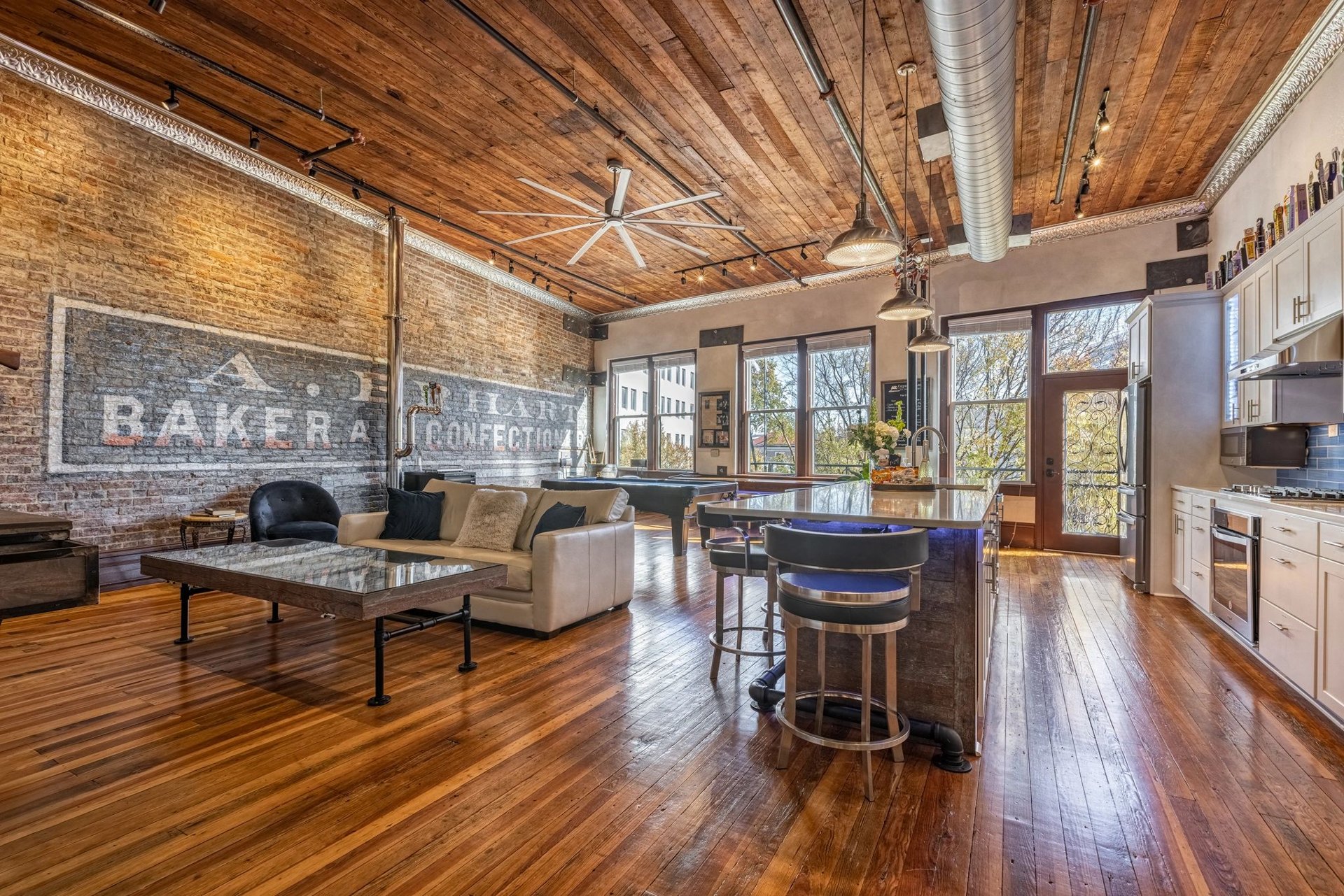 Restored historic loft with exposed brick, original timber ceilings, and inviting interiors